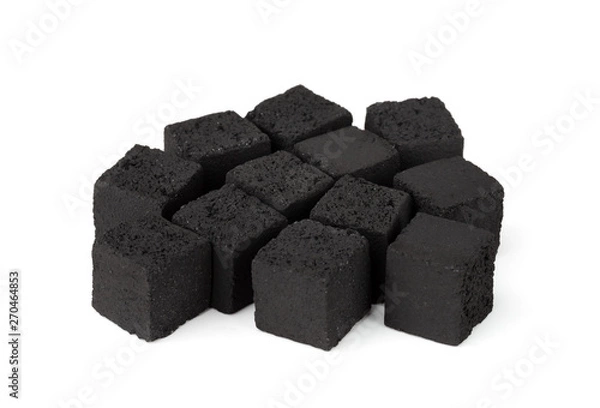 Fototapeta Coconut charcoal on a white background. Coconut coal cubes for hookah close-up.