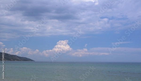 Obraz  large white clouds against the sea
