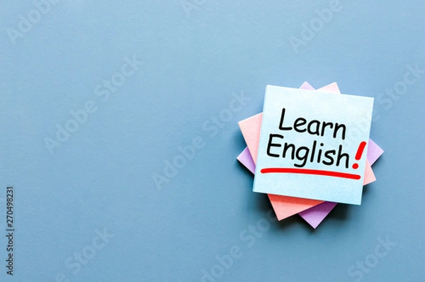 Fototapeta Learn english - note at blue background with empty space for text