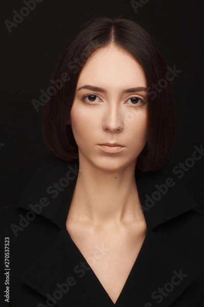 Obraz Portrait of a beautiful woman in a  black jacket. Studio photo session