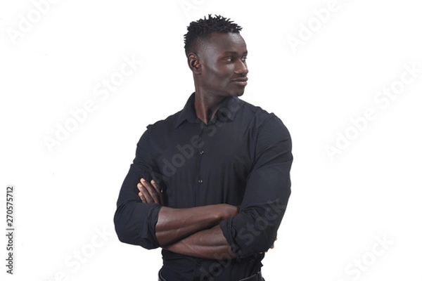 Fototapeta portrait of an african man with arms crossed and looking to the side,