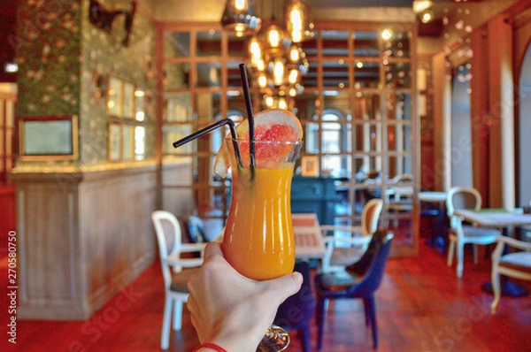 Fototapeta a tall glass cup with a of pumpkin grapefruit smoothie decorated