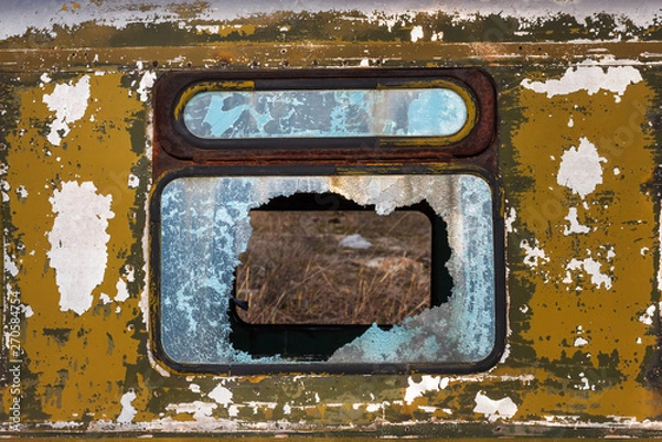 Fototapeta Front view of the broken window glass of the old abandoned rusty bus