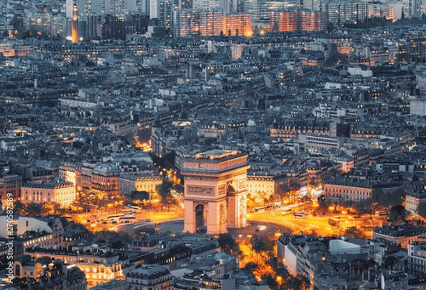 Fototapeta Aerial view of the Arc de Triomphe de l'Etoile (The Triumphal Arch) in Paris at sunset with traffic lights.
