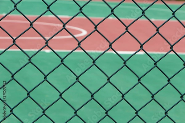 Fototapeta Wire guardrail for outdoor plastic basketball court