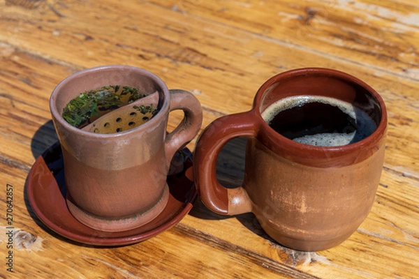 Fototapeta two clay mugs with a drink inside