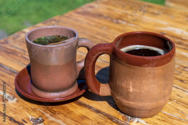 Fototapeta two clay mugs with a drink inside