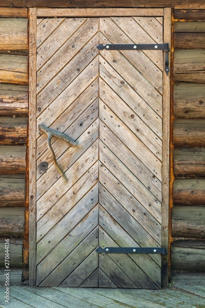 Fototapeta wooden door with a handle branch