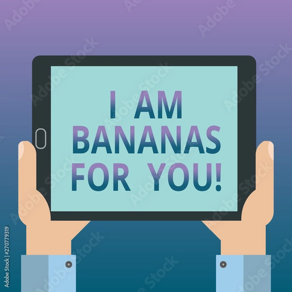 Fototapeta Handwriting text writing I Am Bananas For You. Concept meaning To be crazy for someone in loved happy emotion Hu analysis Hand Holding Blank Screen Tablet Smartphone Display Unit photo