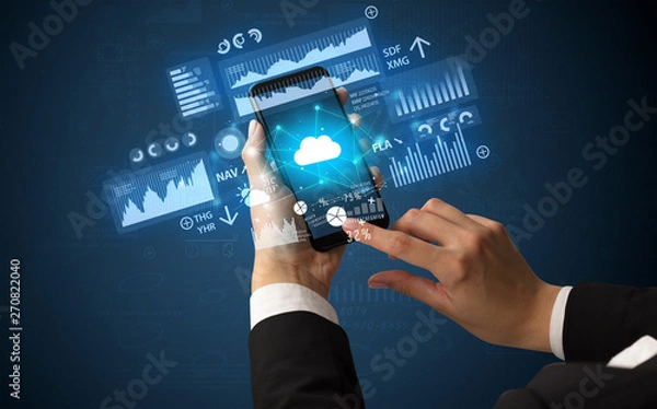 Fototapeta Female hand using smartphone with financial tracking concept illustrated by graphs and symbols