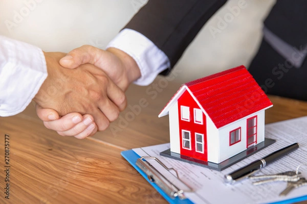 Fototapeta Estate agent shaking hands with customer after contract signature, Business Signing a Contract Buy - sell house, Home for rent concept.