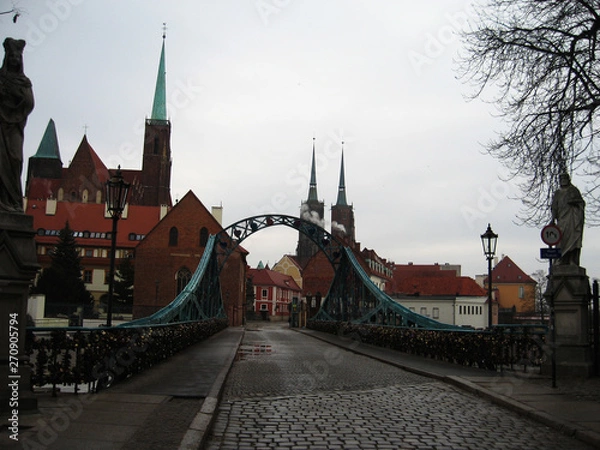Fototapeta Beautiful view of the historic part of Wroclaw over the bridge and the paved road. Poland.
