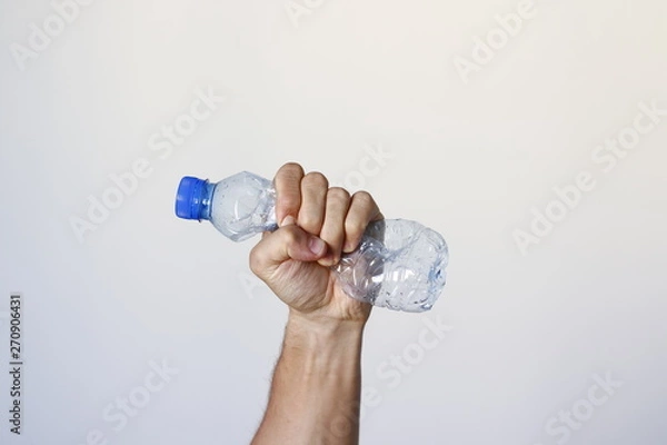 Fototapeta Hand squeezing Plastic Bottle