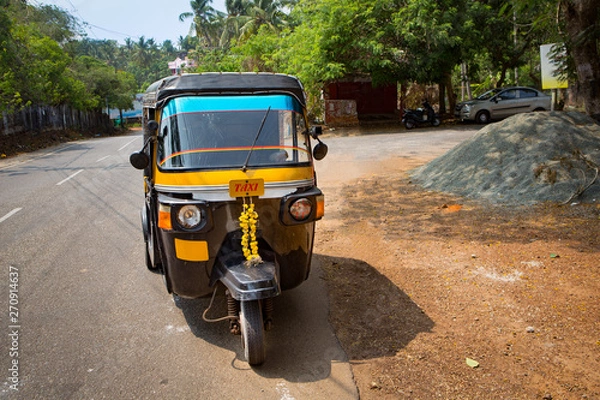 Obraz tuk tuk taxi driving  on a sunny day in the streets in the south of of india