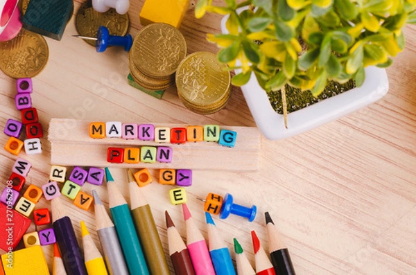 Obraz Business Campaign Concept background, colorful cube with word MARKETING PLAN on wooden desk