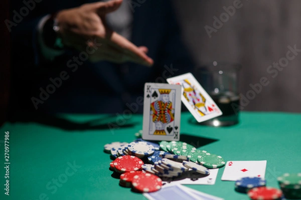 Fototapeta professional poker game. Green poker table with two games. poker player folds by throwing cards on the table