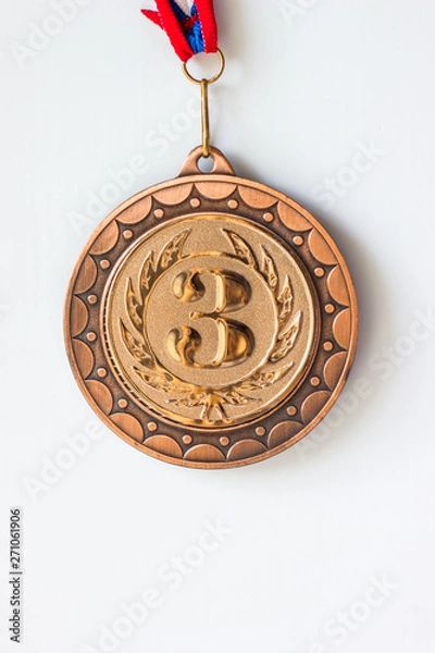 Fototapeta Gold silver bronze medals. Champion winner of the metallic medal award, close-up on a white background.