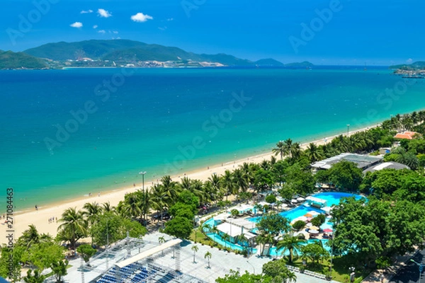 Fototapeta Aerial view at tropical resort on the beach with blue water and island in ocean