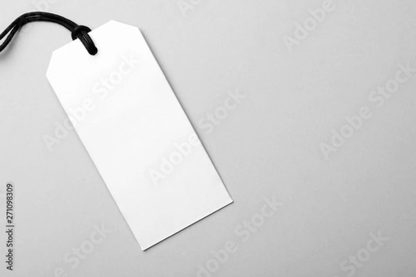 Fototapeta Cardboard tag with space for text on light background, top view
