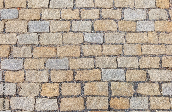 Fototapeta Old road paved with granite stones.