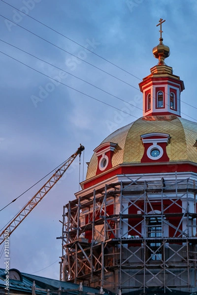 Fototapeta Reconstruction process of the orthodox cathedral using scaffolding