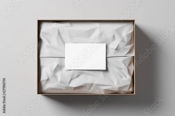 Fototapeta Otwórz pudełko z białym papierem do pakowania i wizytówką na jasnym tle. Prezent biznesowy. Makieta. Widok z góry. Renderowanie 3d