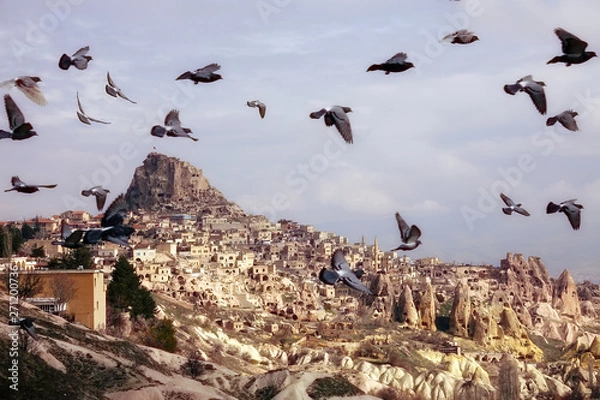 Obraz scenic landscape of old town of Cappadocia and flying pigeons in middle east Turkey
