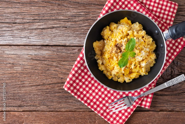 Obraz Scrambled egg on pan. Top view with Copy space.