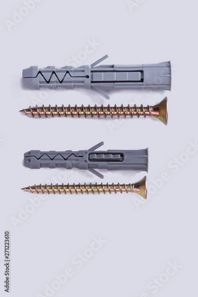 Fototapeta Screws and dowels on white background. Self-tapping screw and dowel. Tools for wood work.