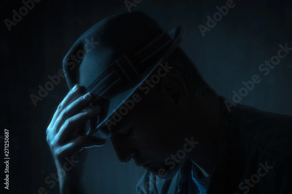 Obraz low key portrait of man with borsalino type hat