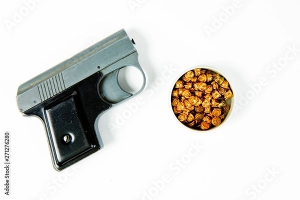 Fototapeta Old used gray starting pistol with black grip - box of small dummy ammunition