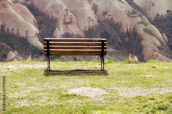 Fototapeta close up empty bench on green grass landscape hill