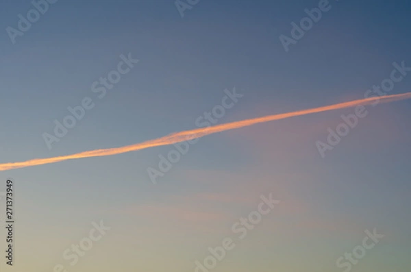 Fototapeta Trail from the plane in the evening sky