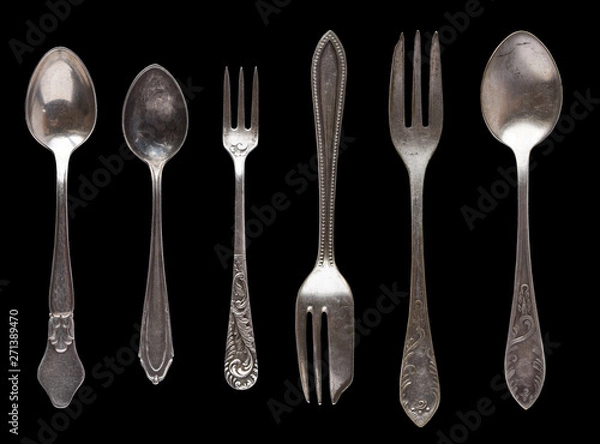 Fototapeta Beautiful old vintage knifes and spoons isolated on black background. Top view. Retro silverware