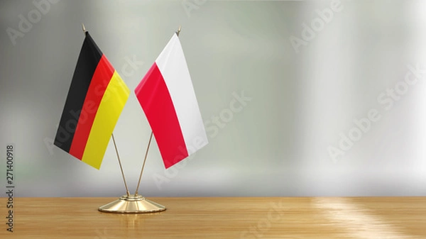 Obraz Polish and German flag pair on a desk over defocused background 