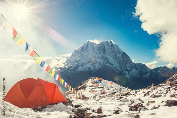Fototapeta Bright orange tent  and prayer flags in the Everest base camp. Mountain peak Everest. Highest mountain in the world. National Park, Nepal.
