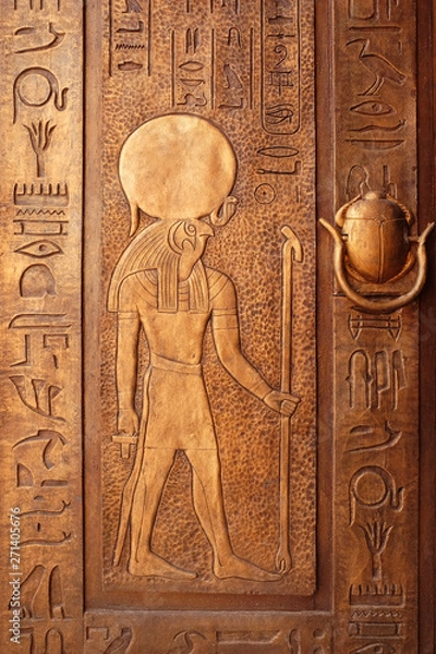 Fototapeta Ancient egypt scene. Hieroglyphic carvings on the exterior walls of an ancient egyptian temple