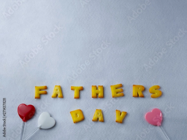 Fototapeta Biscuits, letters, shapes And heart shaped lollipop, arranged on a white background for Father's Day