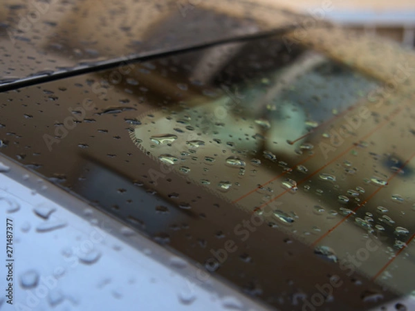 Obraz Close up of water droplets on grey car.