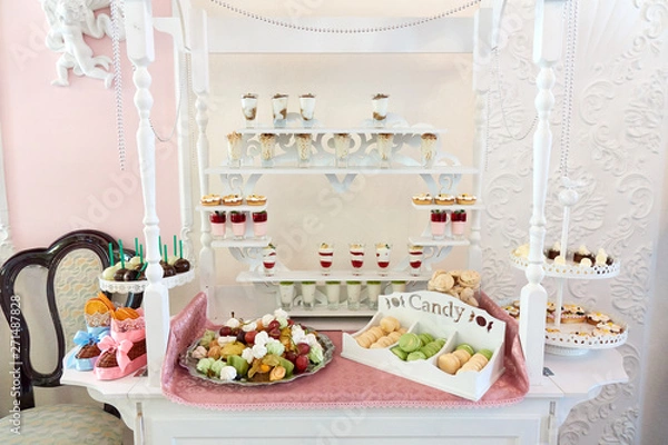 Fototapeta Candy bar on the table with a sweets, fruits, macaroons and other desserts