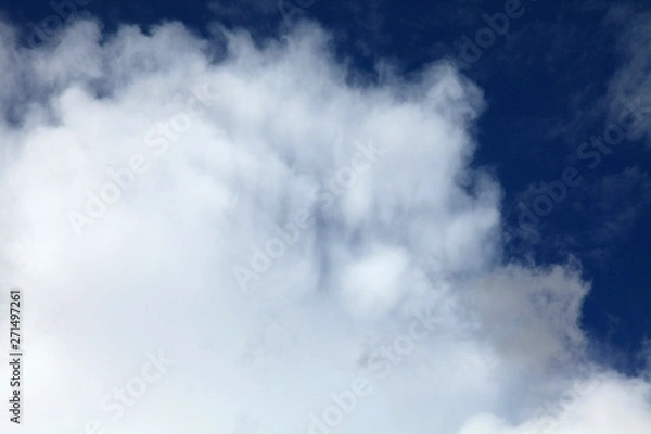 Fototapeta A huge cumulus and cumulonimbus clouds on the blue sky background