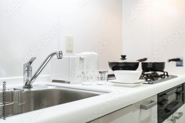 Fototapeta Sink at the small kitchen cabinet in the apartment room