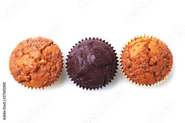 Obraz Assorted with Delicious homemade cupcakes with raisins and chocolate isolated on white background. Muffins. Top view.