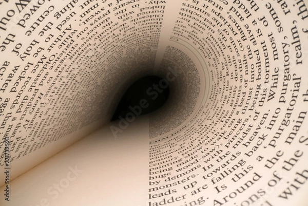 Fototapeta Inside the book concept. Latin letters and words on an tunnel shaped, perspective book page with black dramatic light. Education, knowledge concept