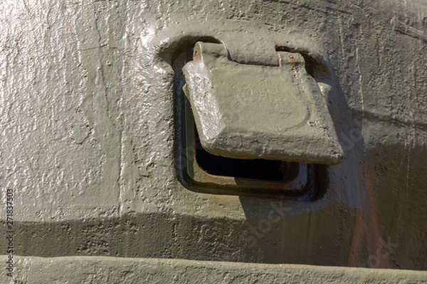 Fototapeta pistol loophole covered with a lid on the tower of a Sherman tank M4A2(76)W. armored embrasure Close-up