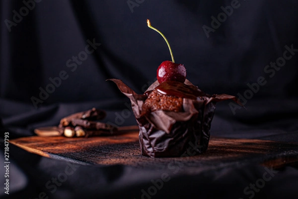 Fototapeta chocolate cupcake with a cherry