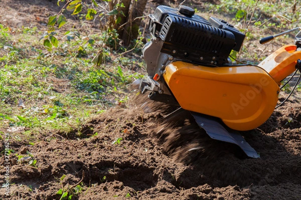Obraz An aerator machine working in the yard
