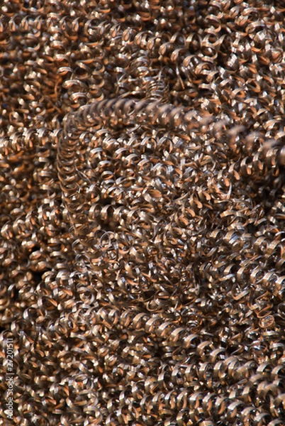 Fototapeta An abstract background of copper-colored metal shavings (swarf)
