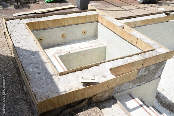 Fototapeta Empty swimming pool under remodel with wooden forms for new tile and coping and concrete