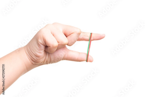 Fototapeta Child hand playing with elastic rubber band isolated on white